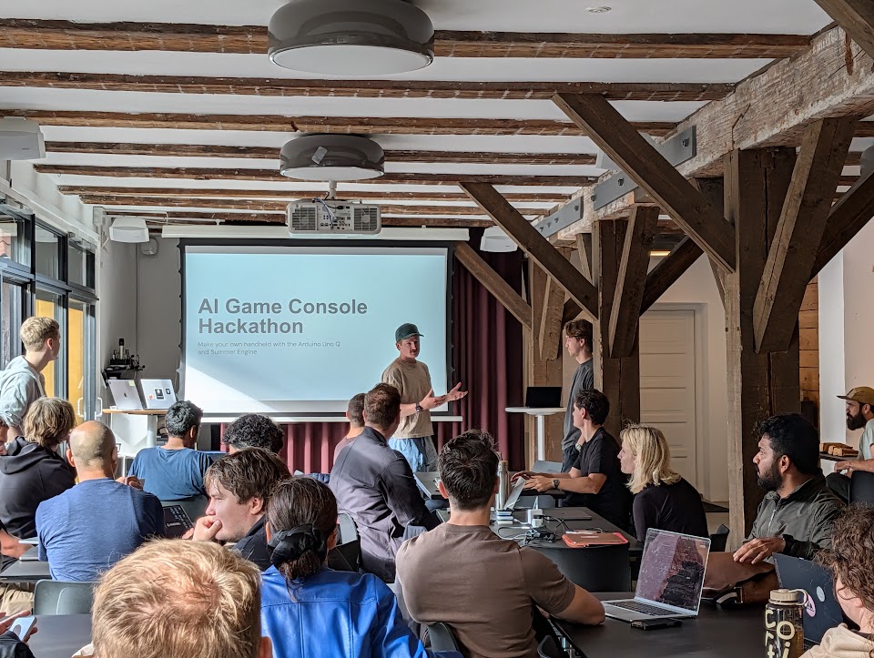People with laptops gathered for the AI Game Console Hackathon in Copenhagen.